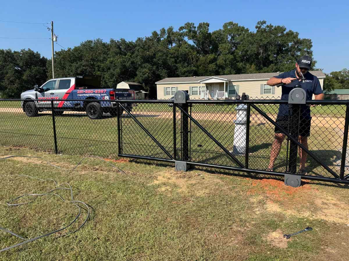 Major League Fence in Mobile Alabama installing a chain link sliding gate