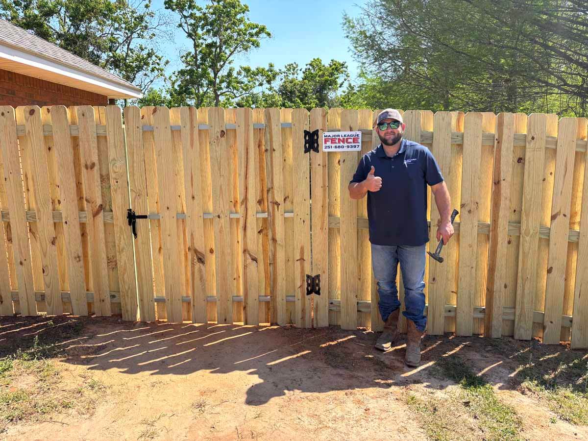 Major League Fence Company installing a wood fence in Mobile Alabama